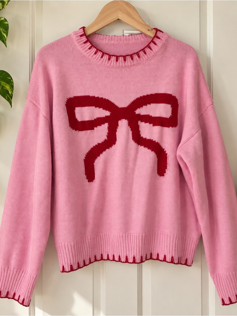 Pink fuzzy sweater with red bow, size medium